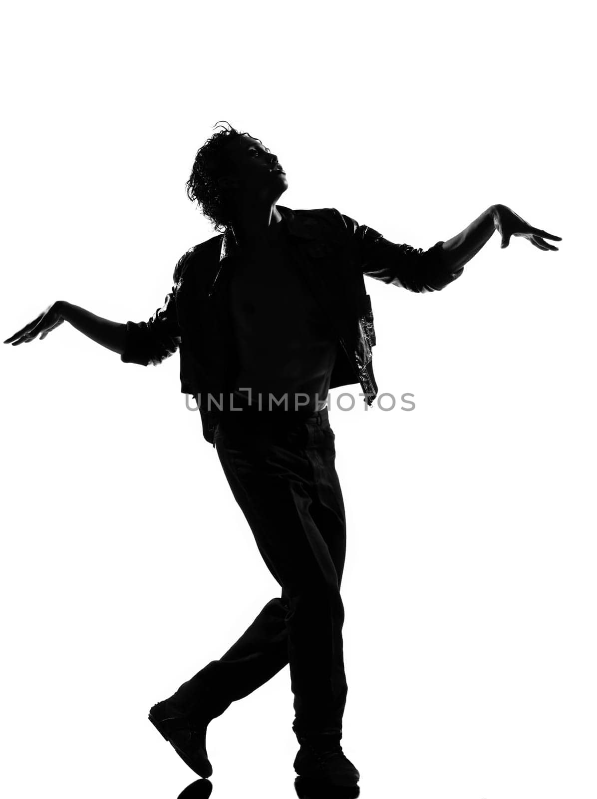 full length silhouette of a young man dancer dancing funky hip hop r&amp b on  isolated  studio white background