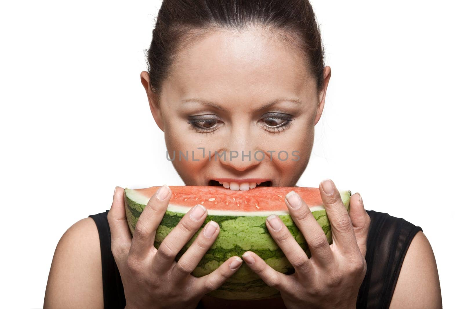Closeup portrait of beautiful Asian woman eating watermelon in studio isolated on white background