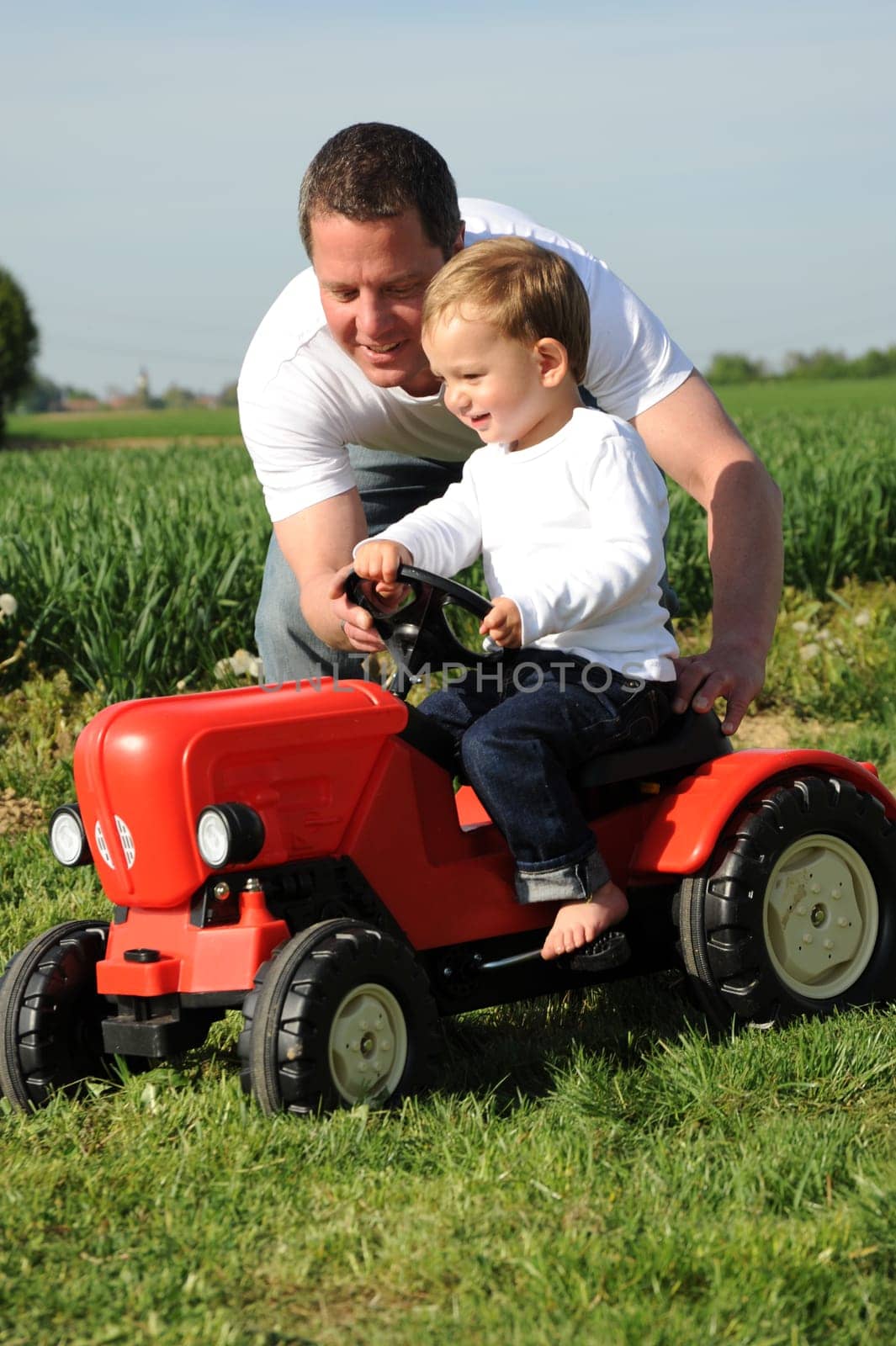 Father and son with red tractor