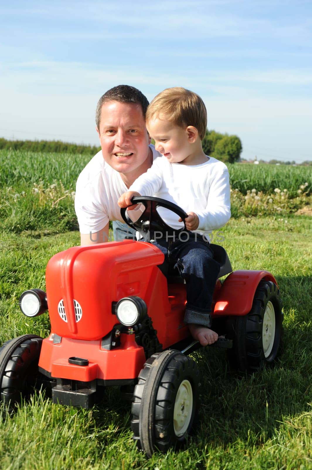 Father and son with red tractor