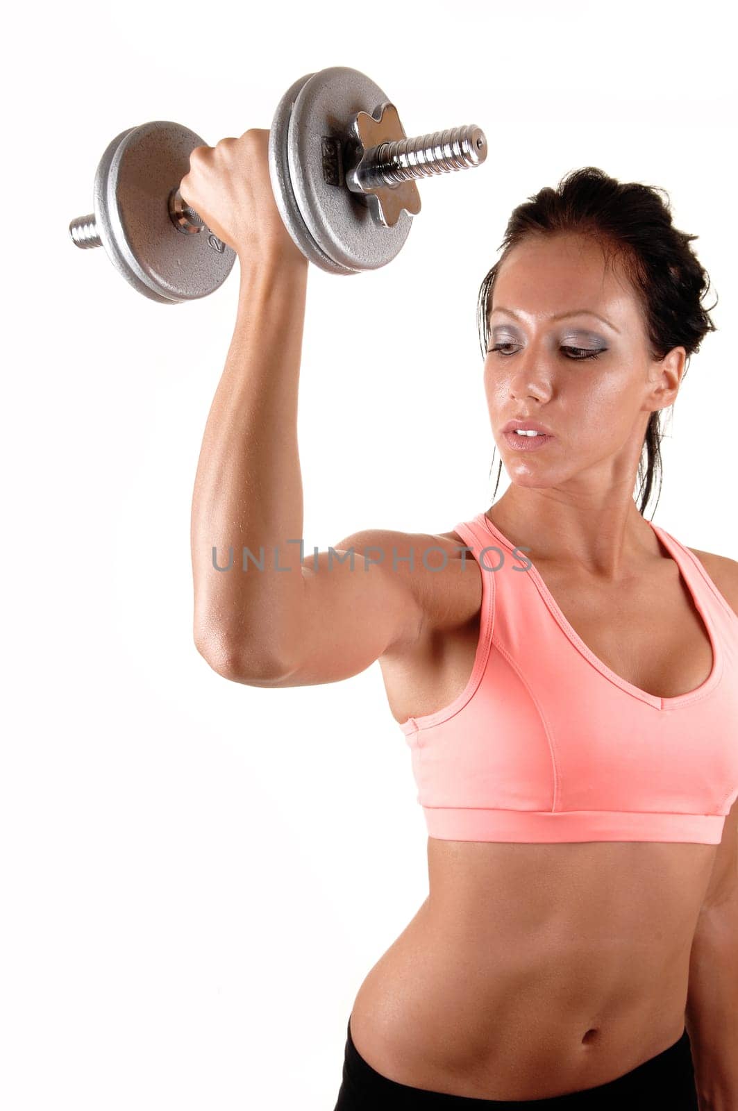 Pretty young woman lifting a dumbbell with her right arm showing her muscles and very lean body, for white background.