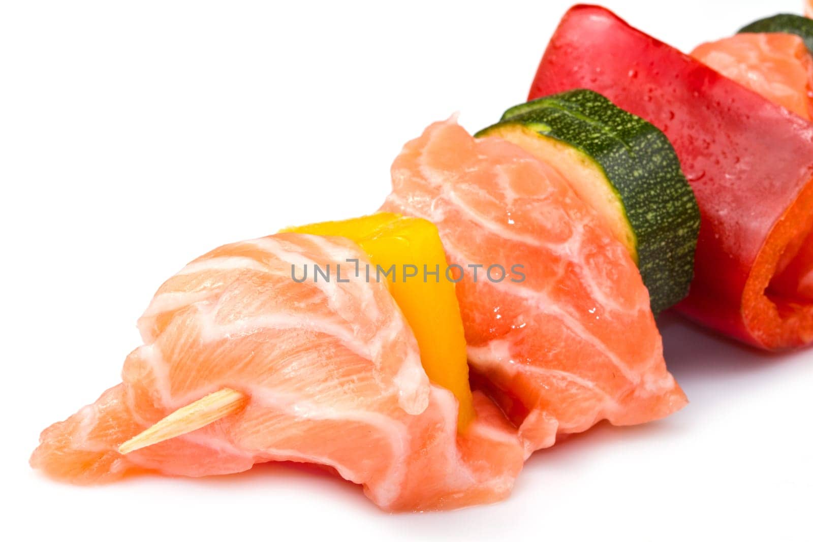 salmon kebab with zucchini and peppers isolated on white background