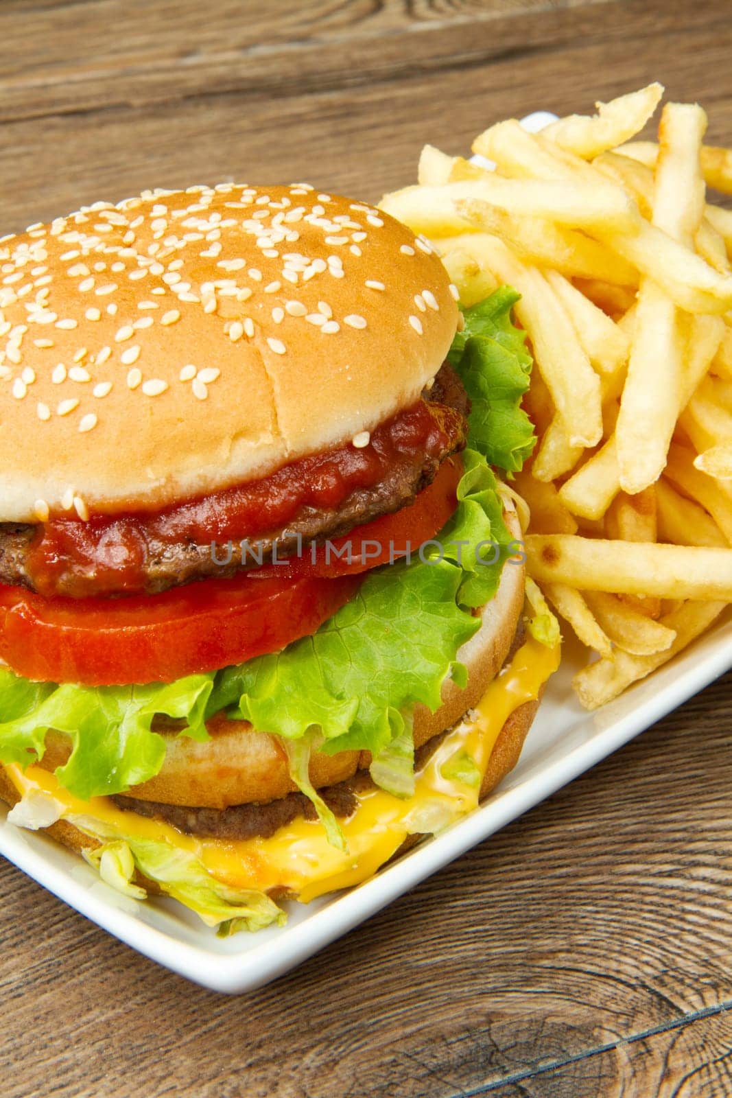 hamburger with potatoes on wooden background