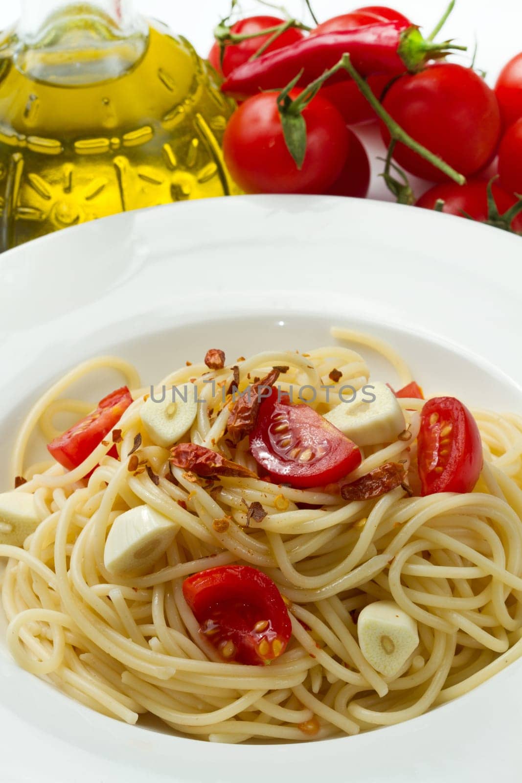 pasta garlic olive oil and red chili pepper closeup on a white dish