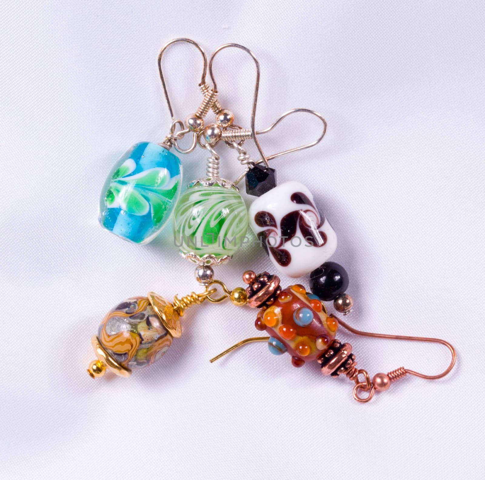 Bead designed earrings made as a hobby and photographed on white cloth