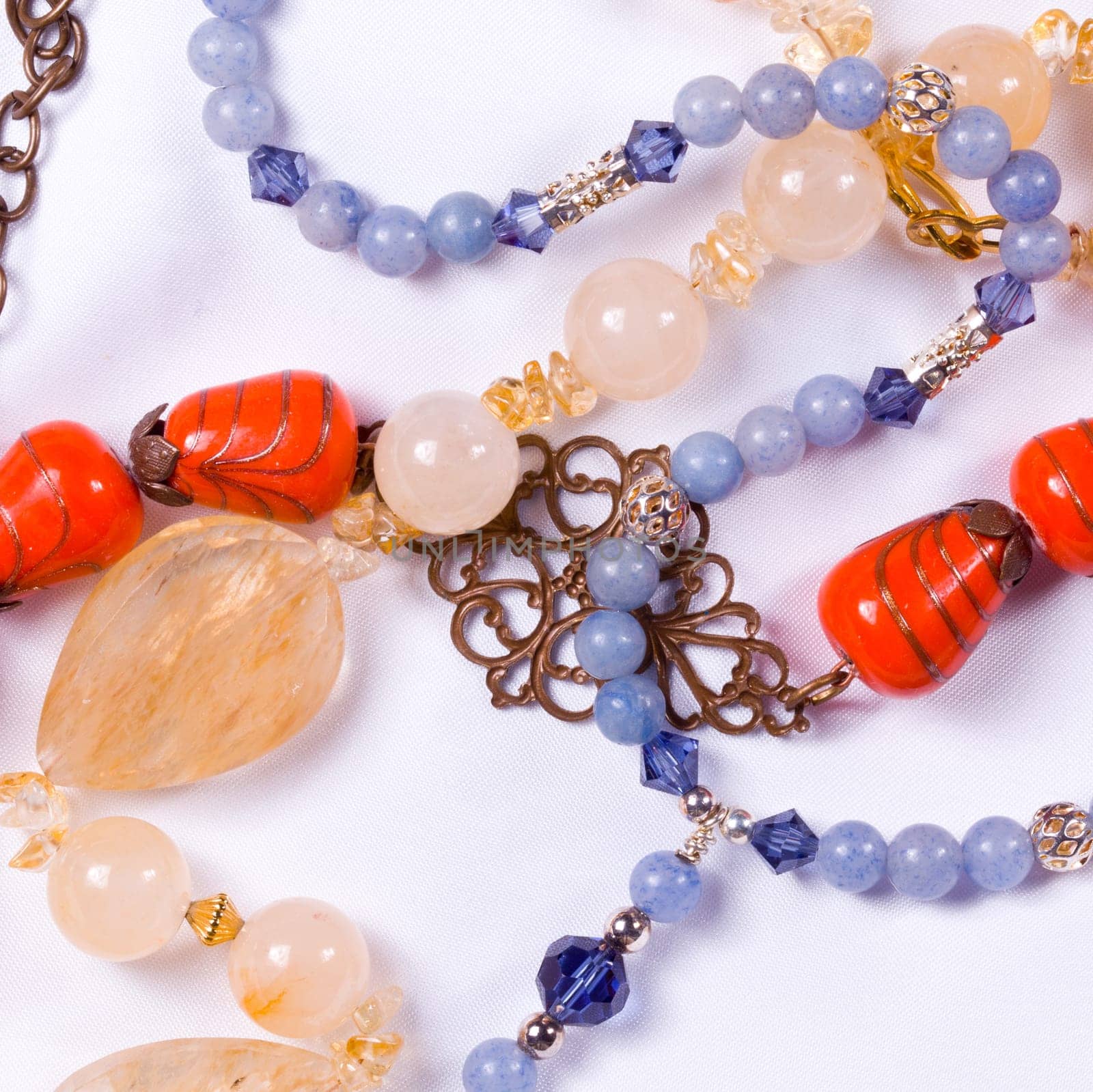 Hand made bead necklaces laying on white cloth