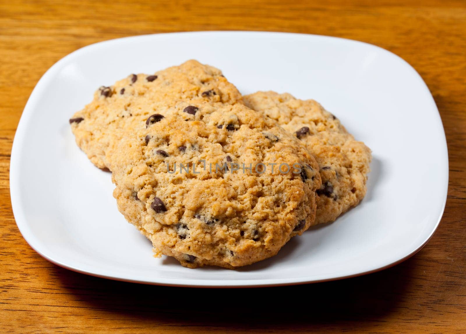 White plate of home made chocolate chip cookies just out of the oven