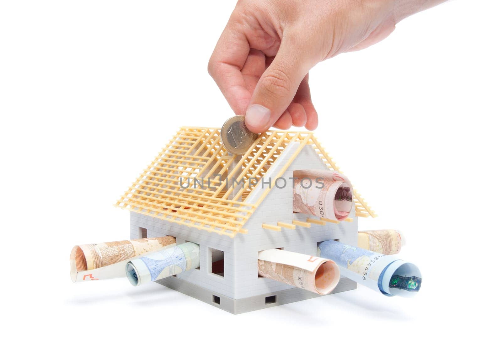 Housing finance, building savings and realty financing (investments) concept. Money and model of the family house.