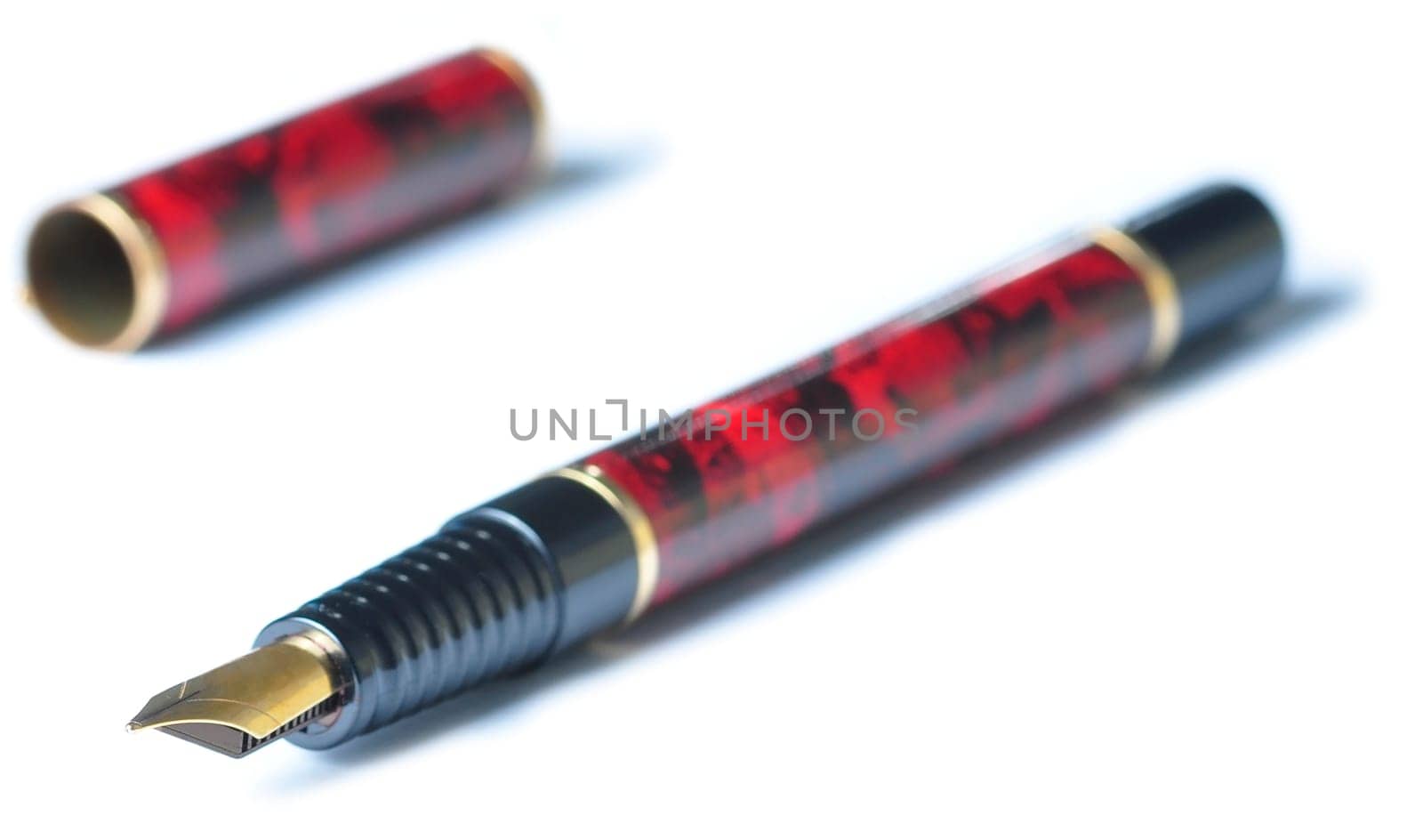 A fountain writing pen, brown and black with a gold tip, isolated in white