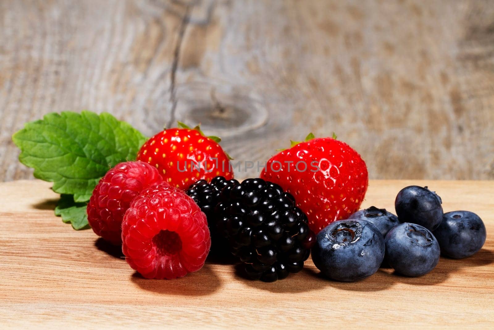 Wild berries on wooden background