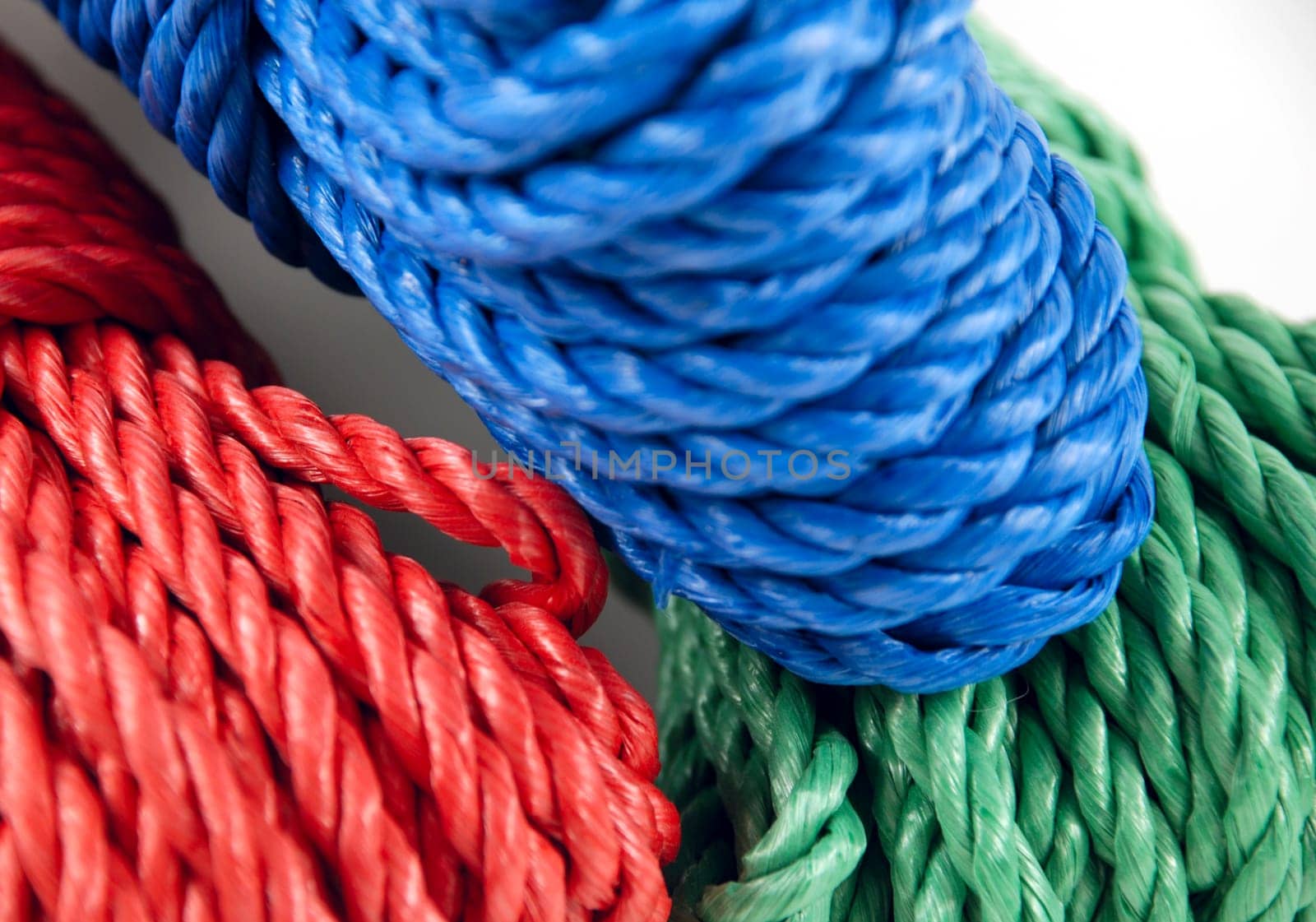 three coils of rope in green, blue and red