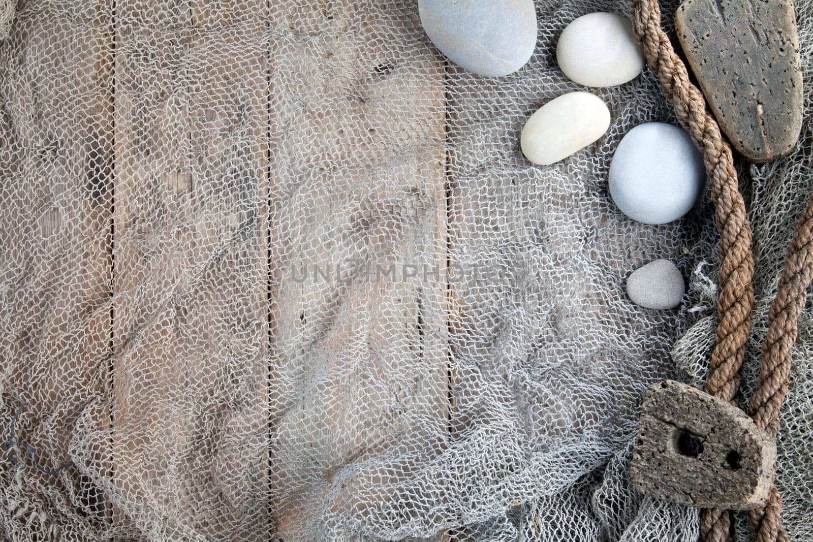 Cork, fishing net and rope with wooden background