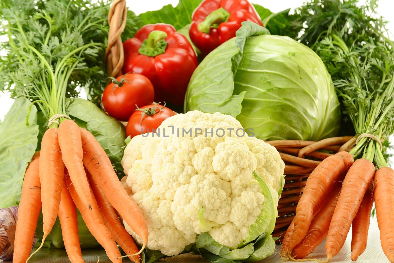 Composition with raw vegetables and wicker basket