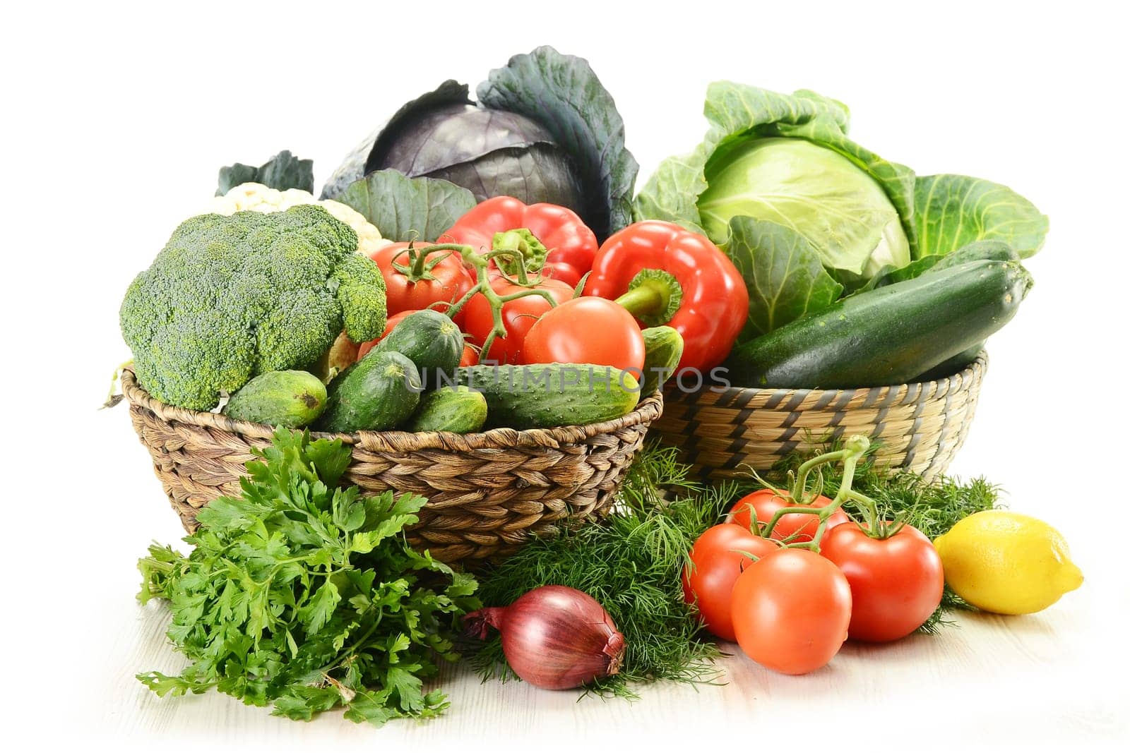 Composition with raw vegetables and wicker basket