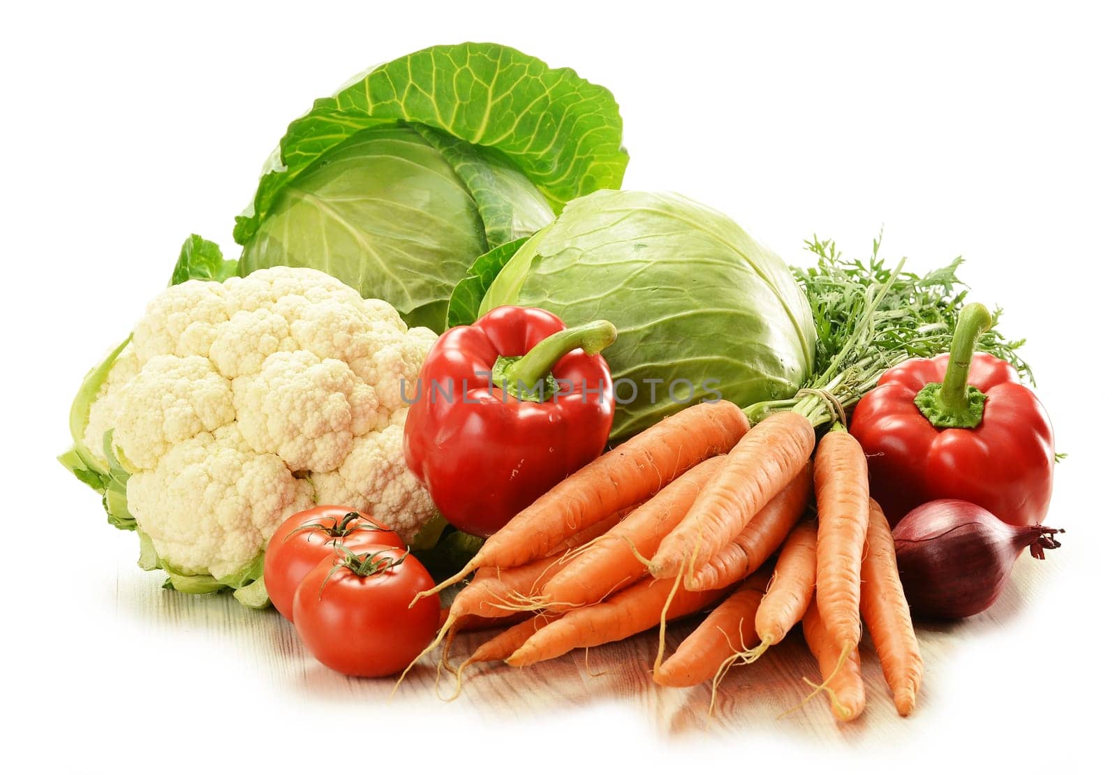 Composition with raw vegetables on white