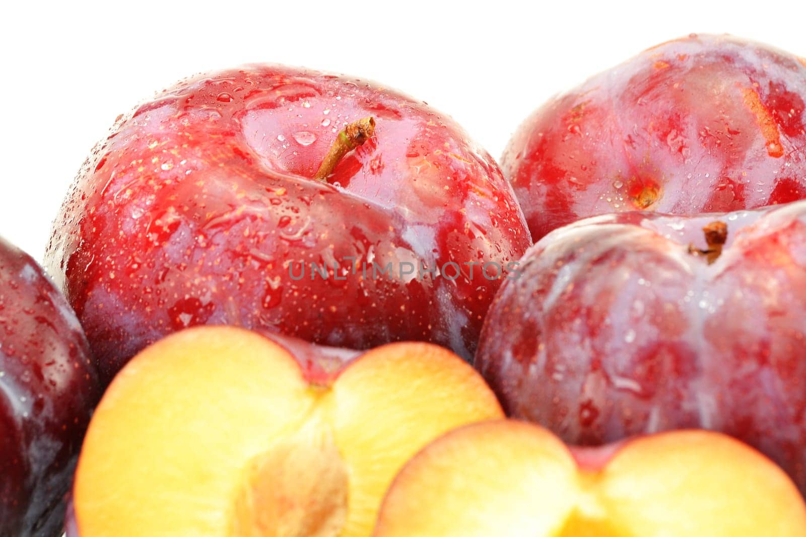 Composition with plums on white background