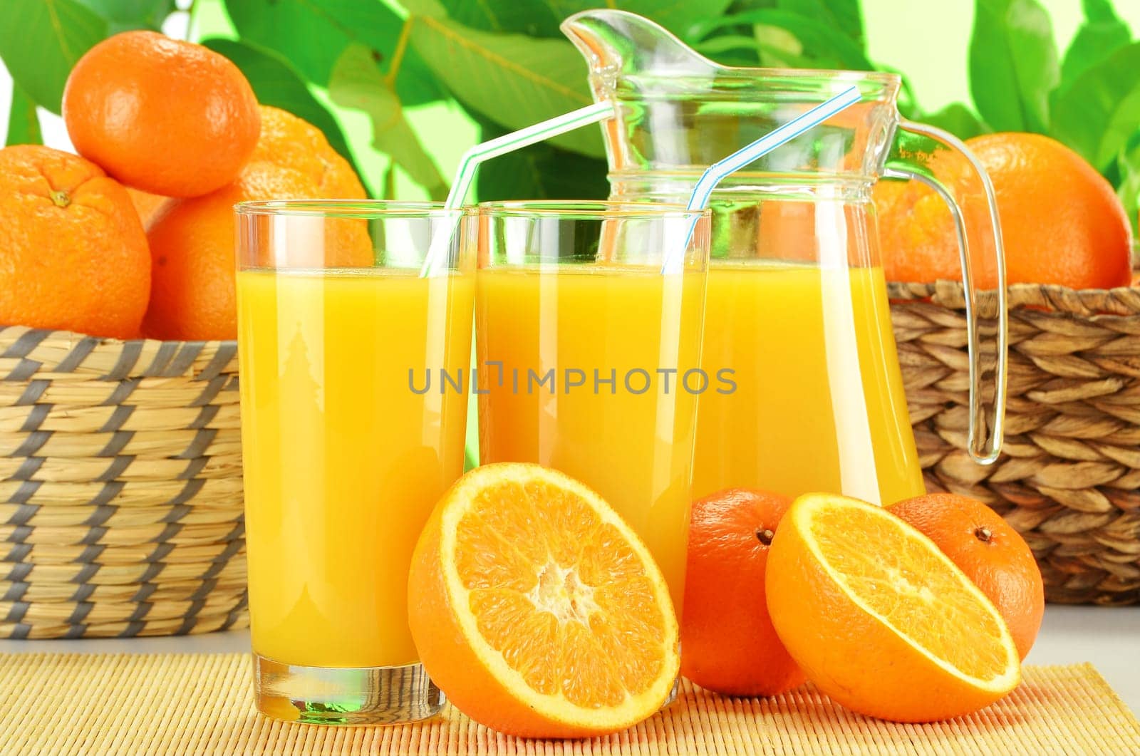 Composition with two glasses of orange juice and fruits