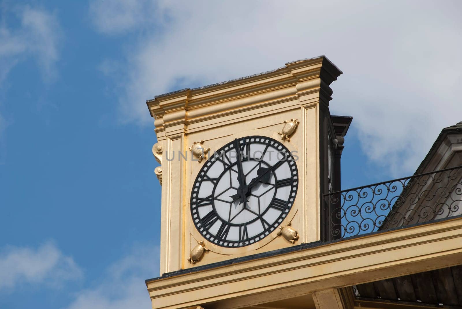 An Antique Gold Coloured Clock on a civic building in an English City