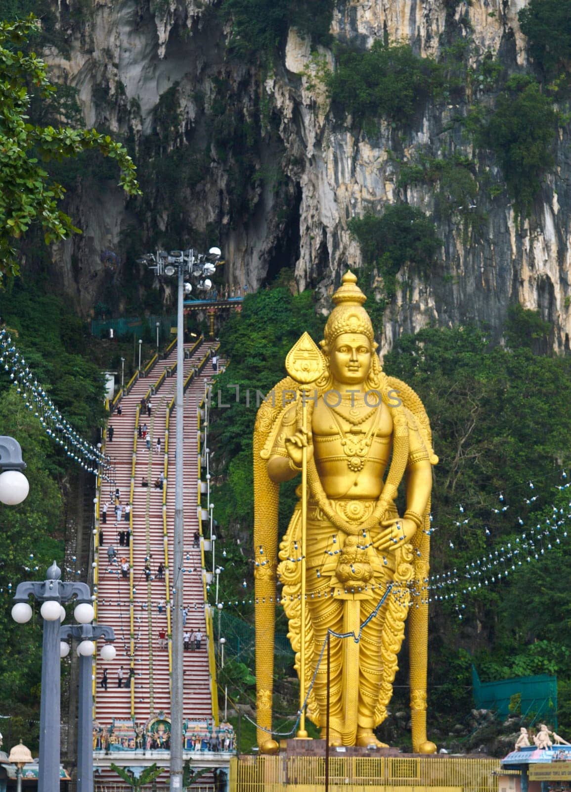 The large gold hindu statue in front of Batu caves in Malaysia.