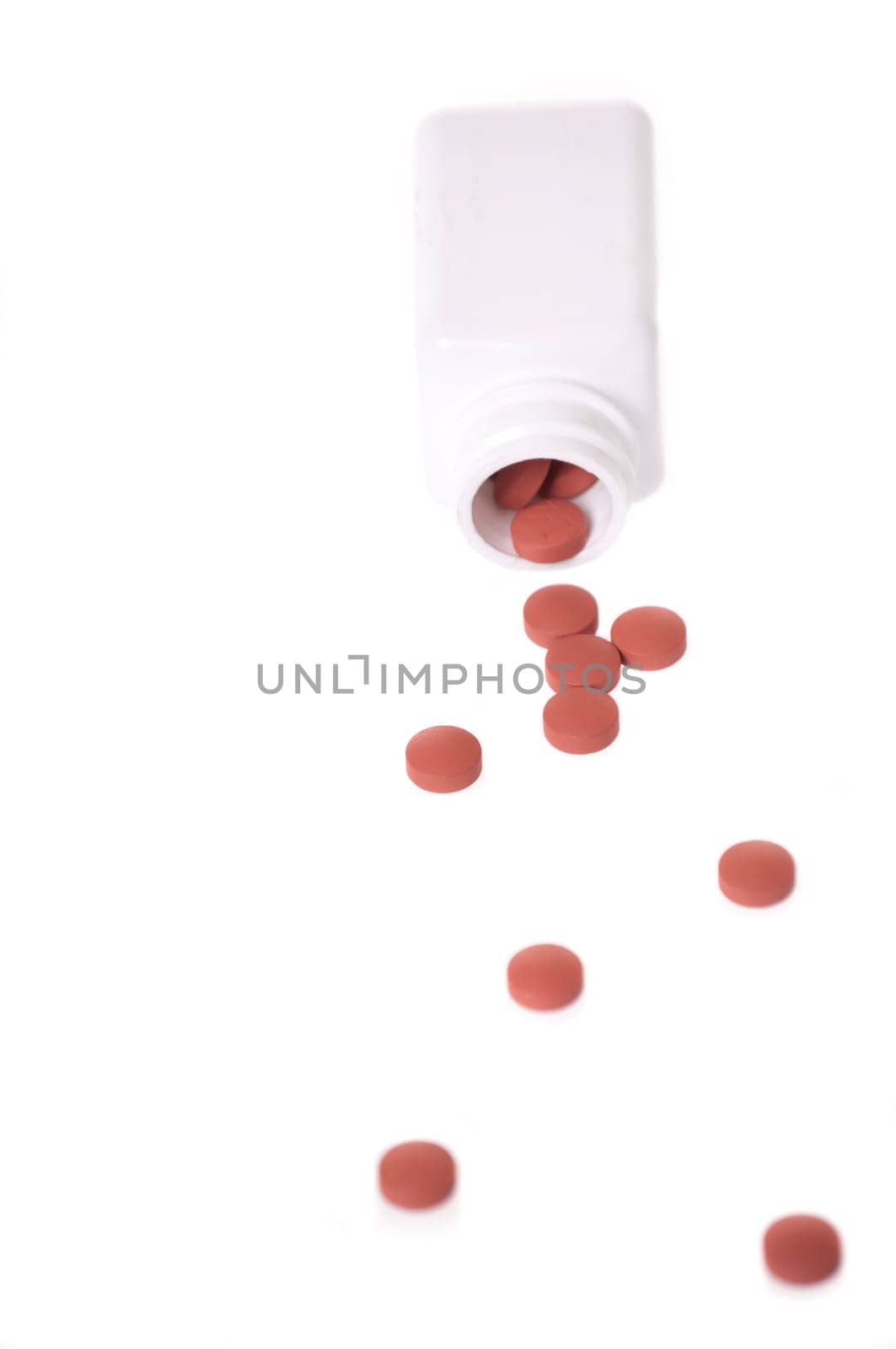 A white pill bottle with red generic pills on a white background.