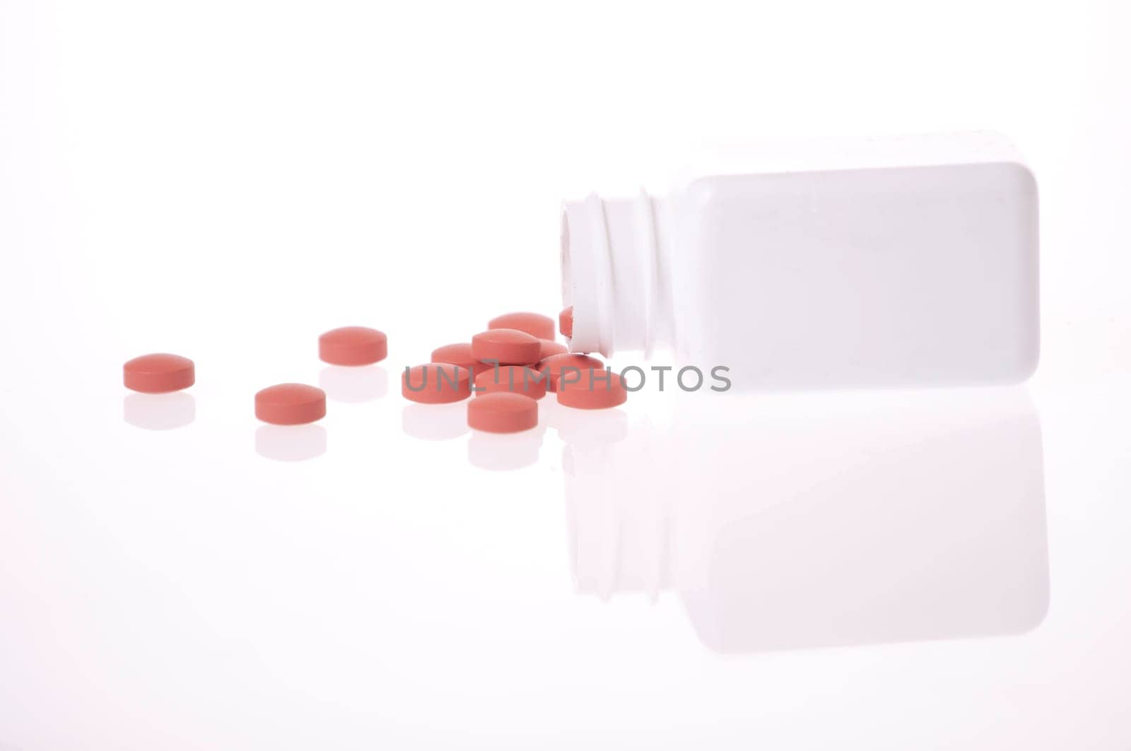 A white pill bottle with red generic pills on a white background.