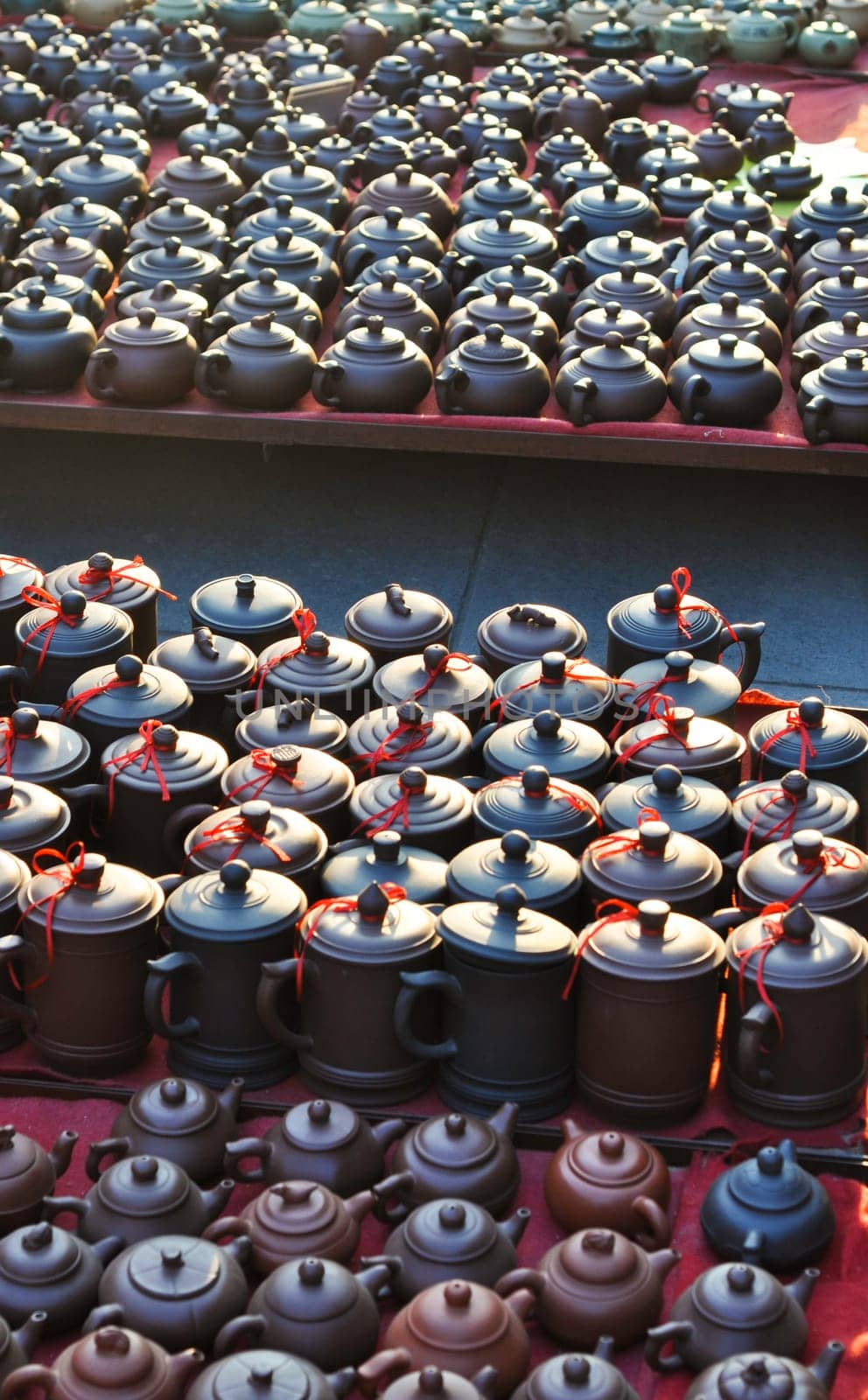 Various chinese teapots and pots for sale in a market