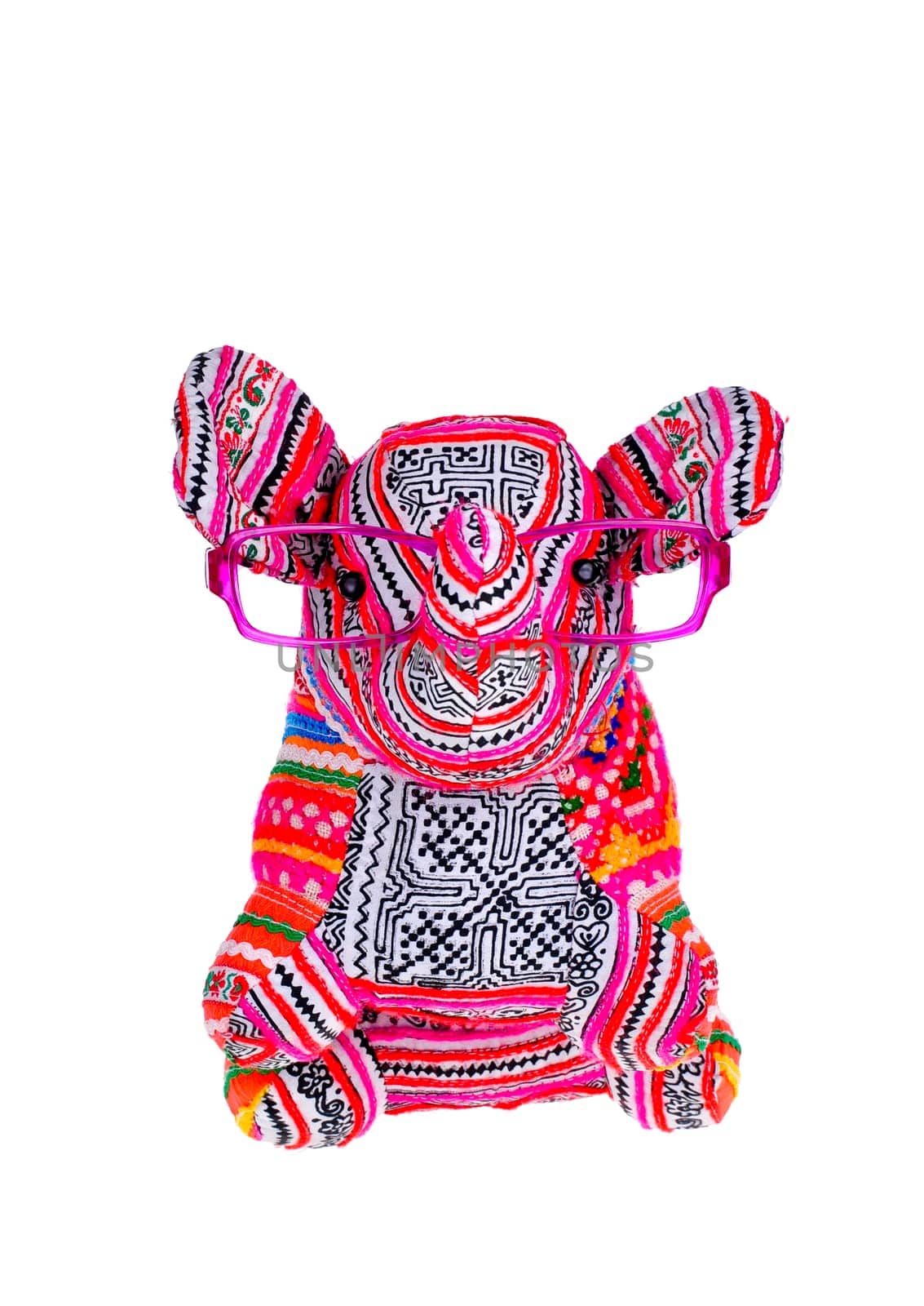 Small stuffed elephant wearing glasses sitting up