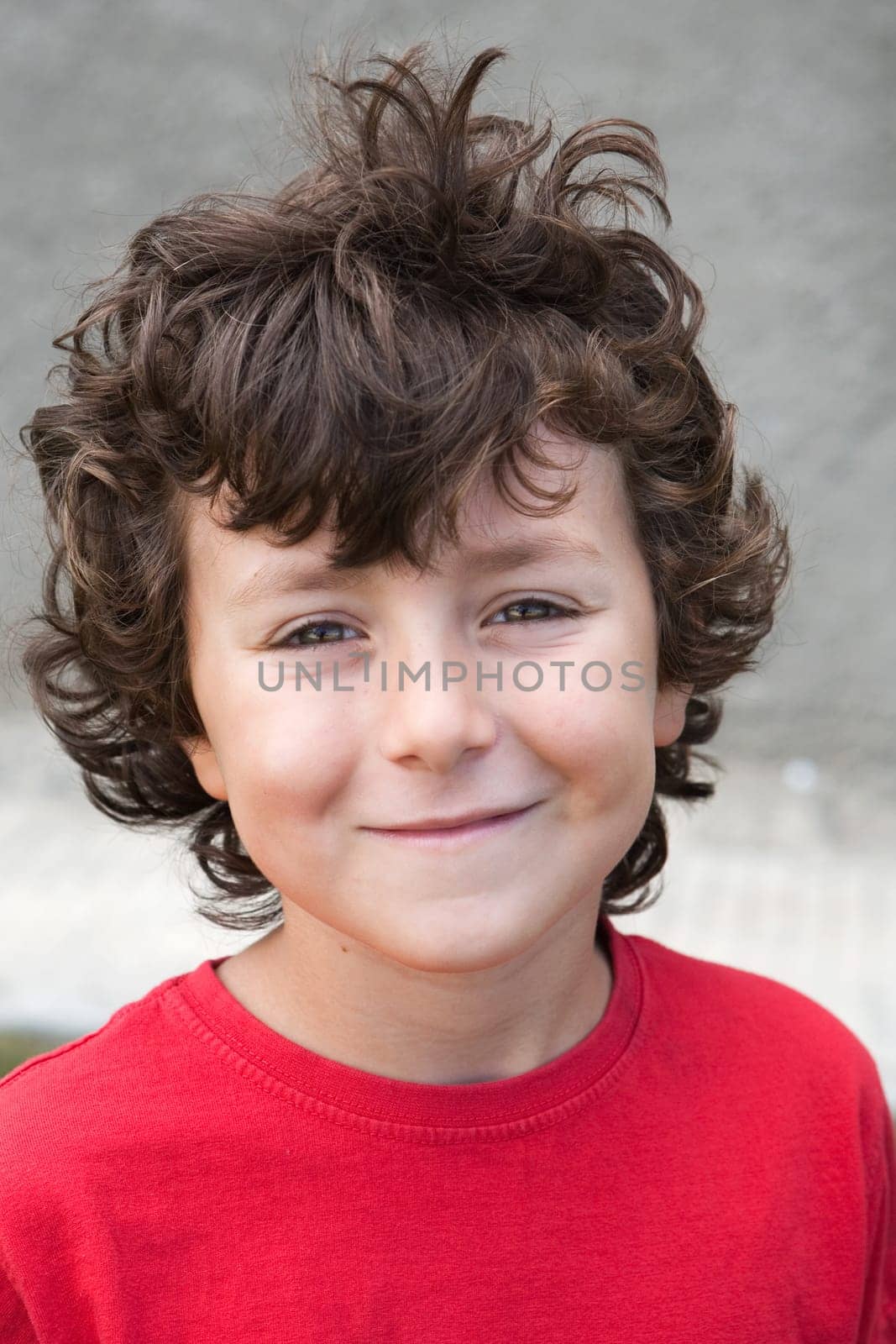 Beautiful little boy with red shirt smiling
