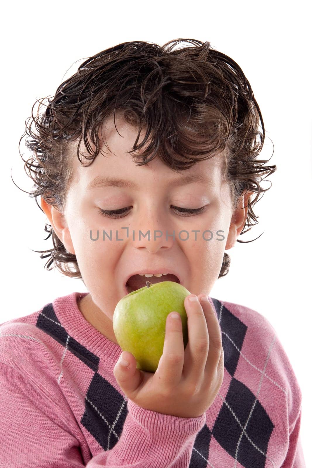 Child with pink jersey biting an apple
