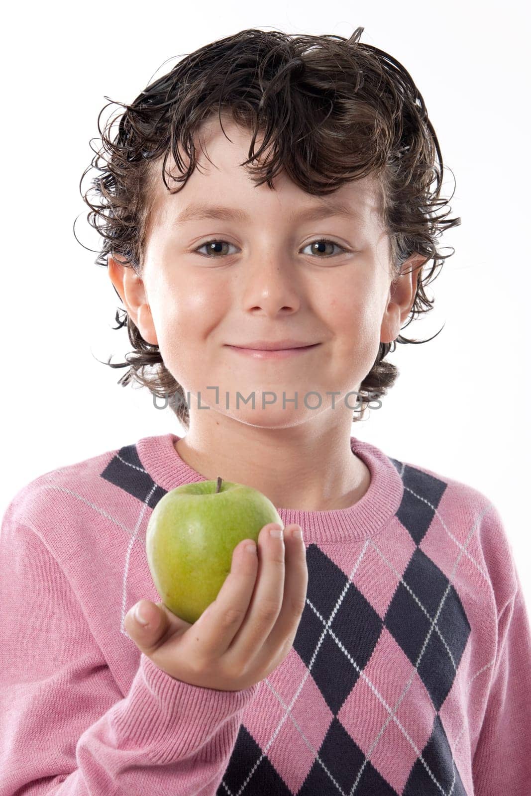 Smiling child with a green apple isolated over white