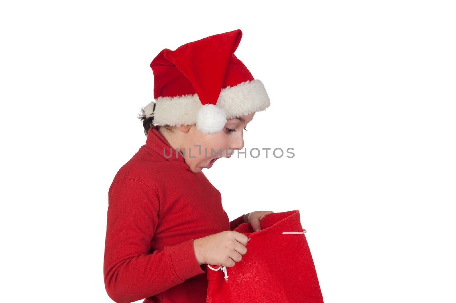 Amazed boy looking in the Christmas bag isolated on white background
