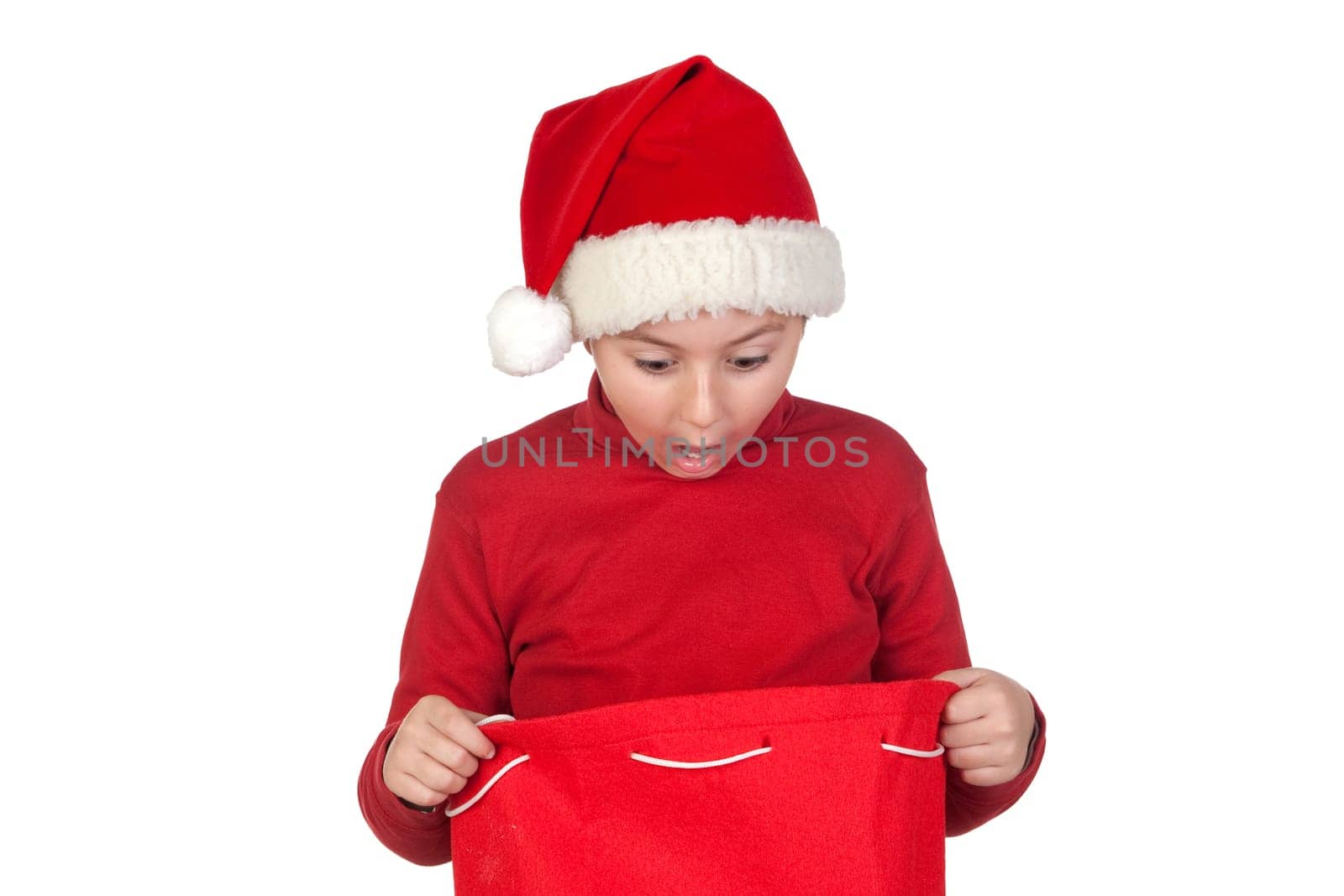 Amazed boy looking in the Christmas bag isolated on white background