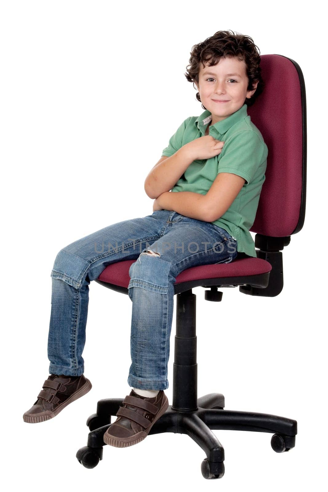 Adorable little boy sitting on big chair isolated on white.