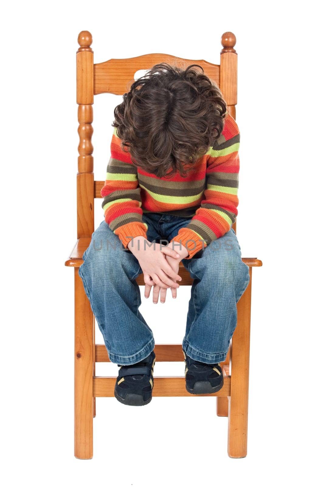 Sad child sitting on a chair isolated on a over white background