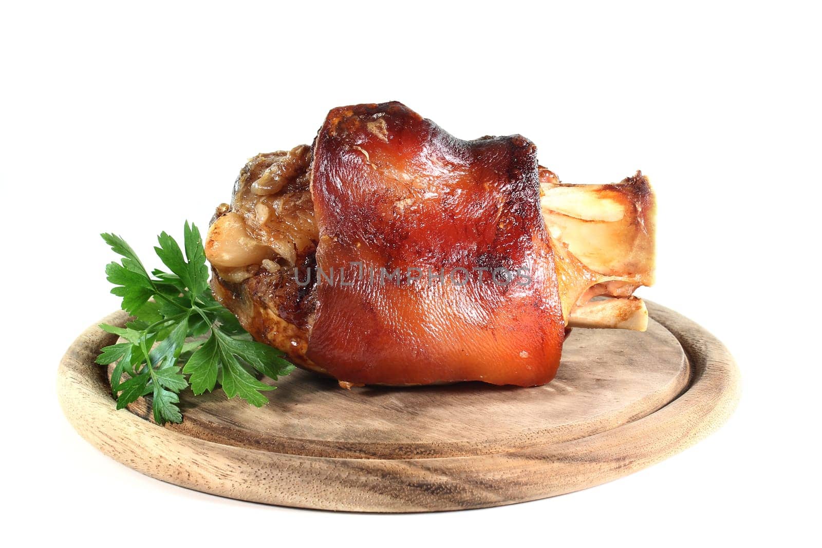 grilled pork knuckle in front of a white background