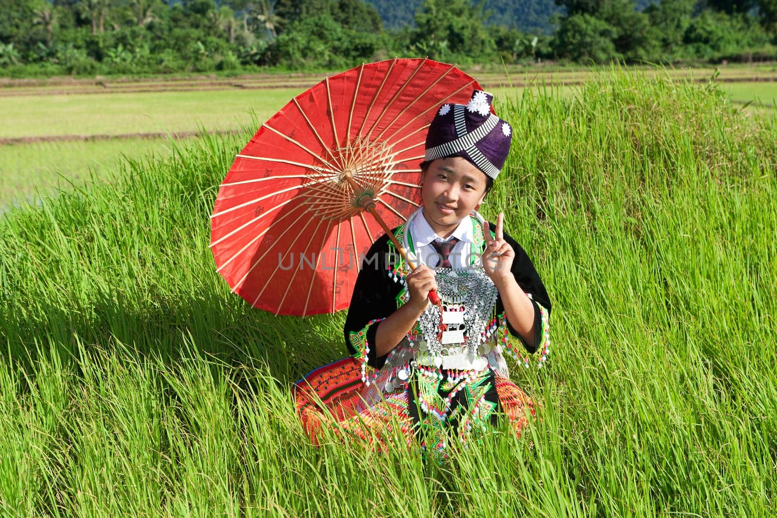 Portrait of Hmong of Laos,with parasol and traditional costume