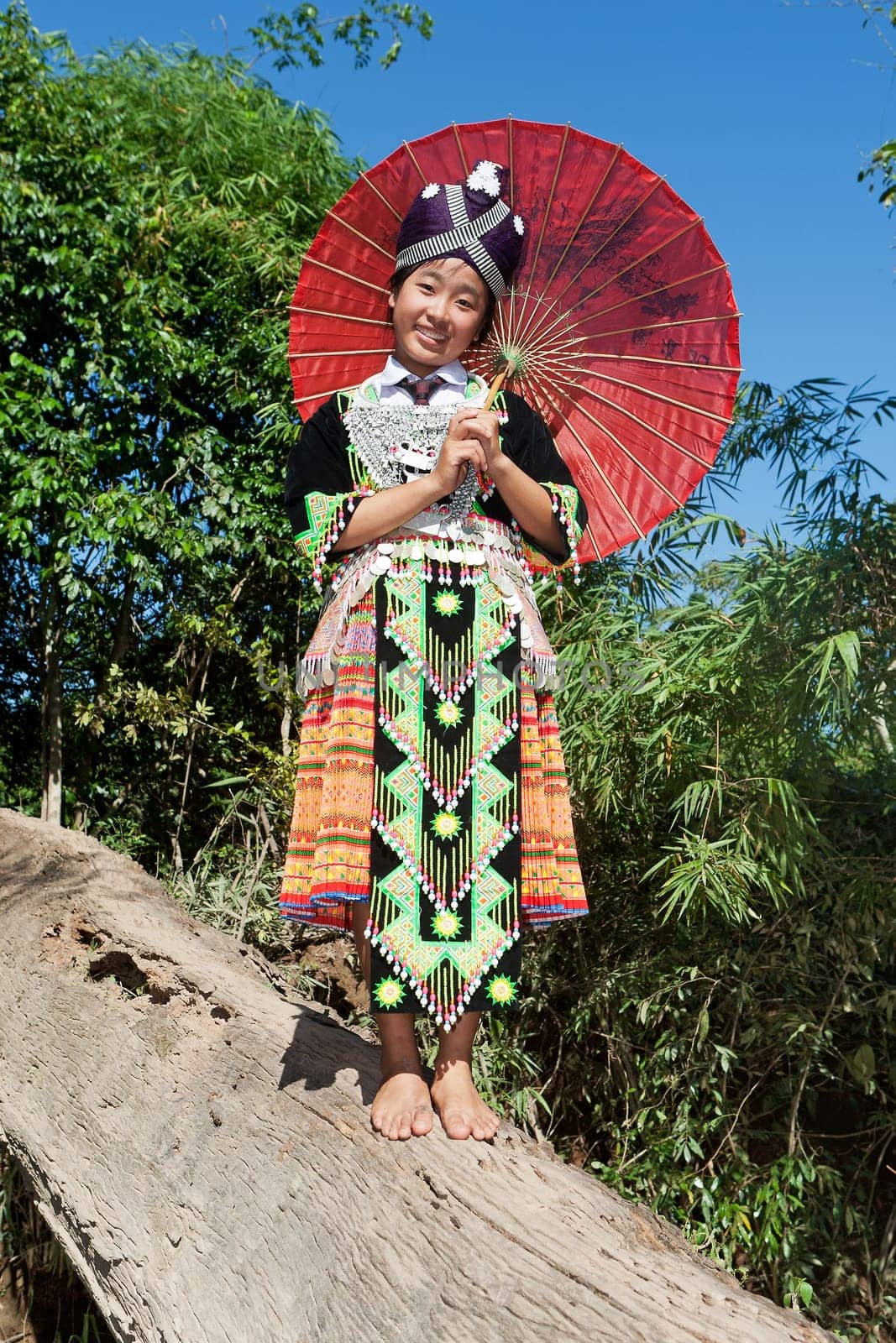 Portrait of Hmong of Laos,with parasol and traditional costume