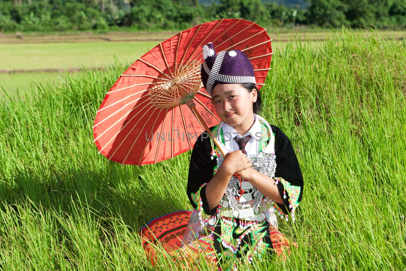 Portrait of Hmong of Laos,with parasol and traditional costume