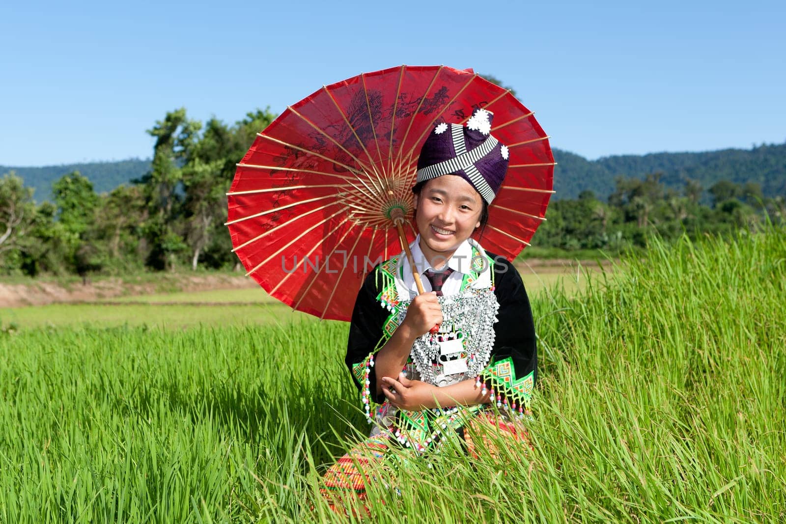 Portrait of Hmong of Laos,with parasol and traditional costume