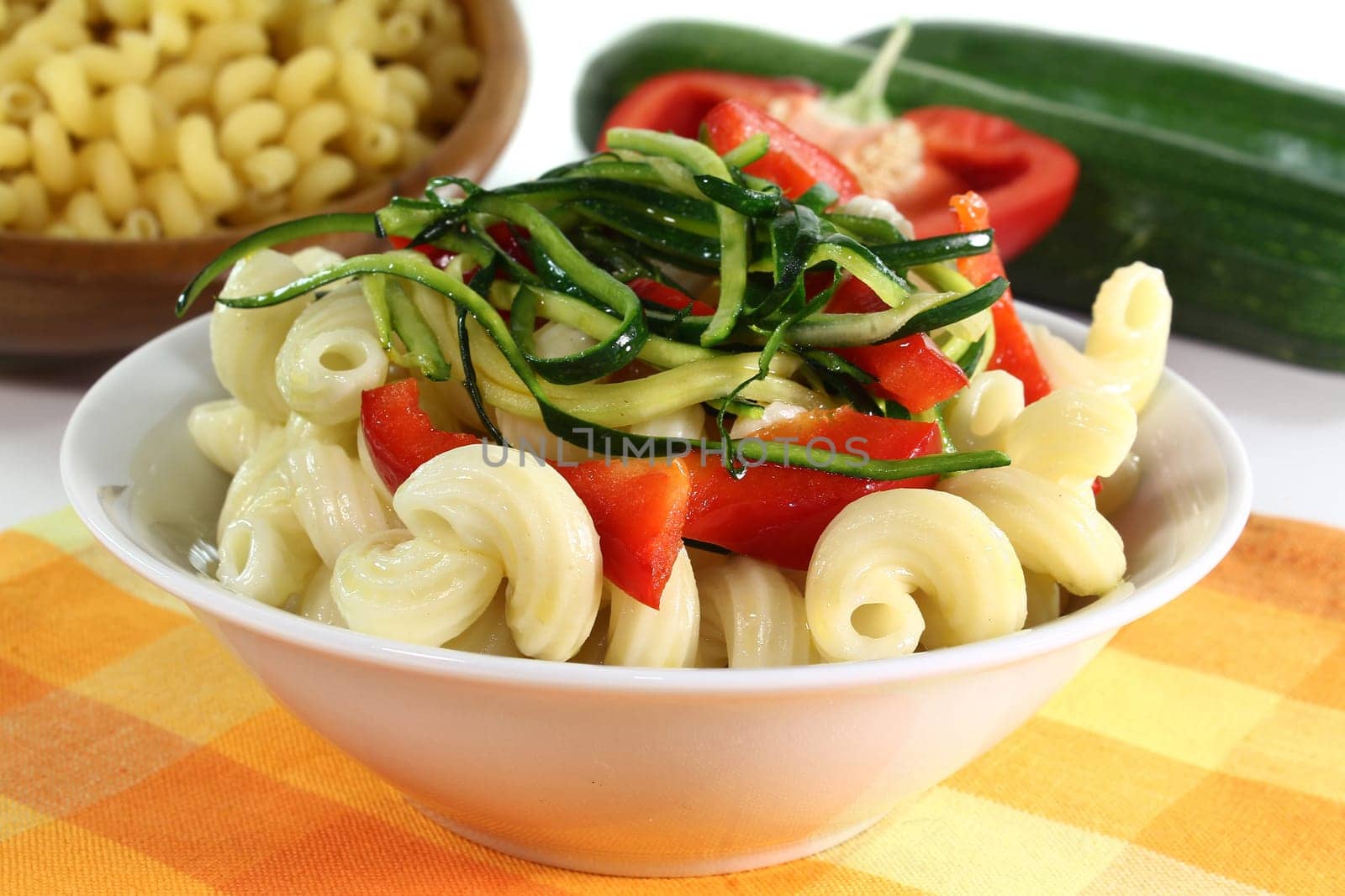 a white bowl with a vegetarian pasta dish