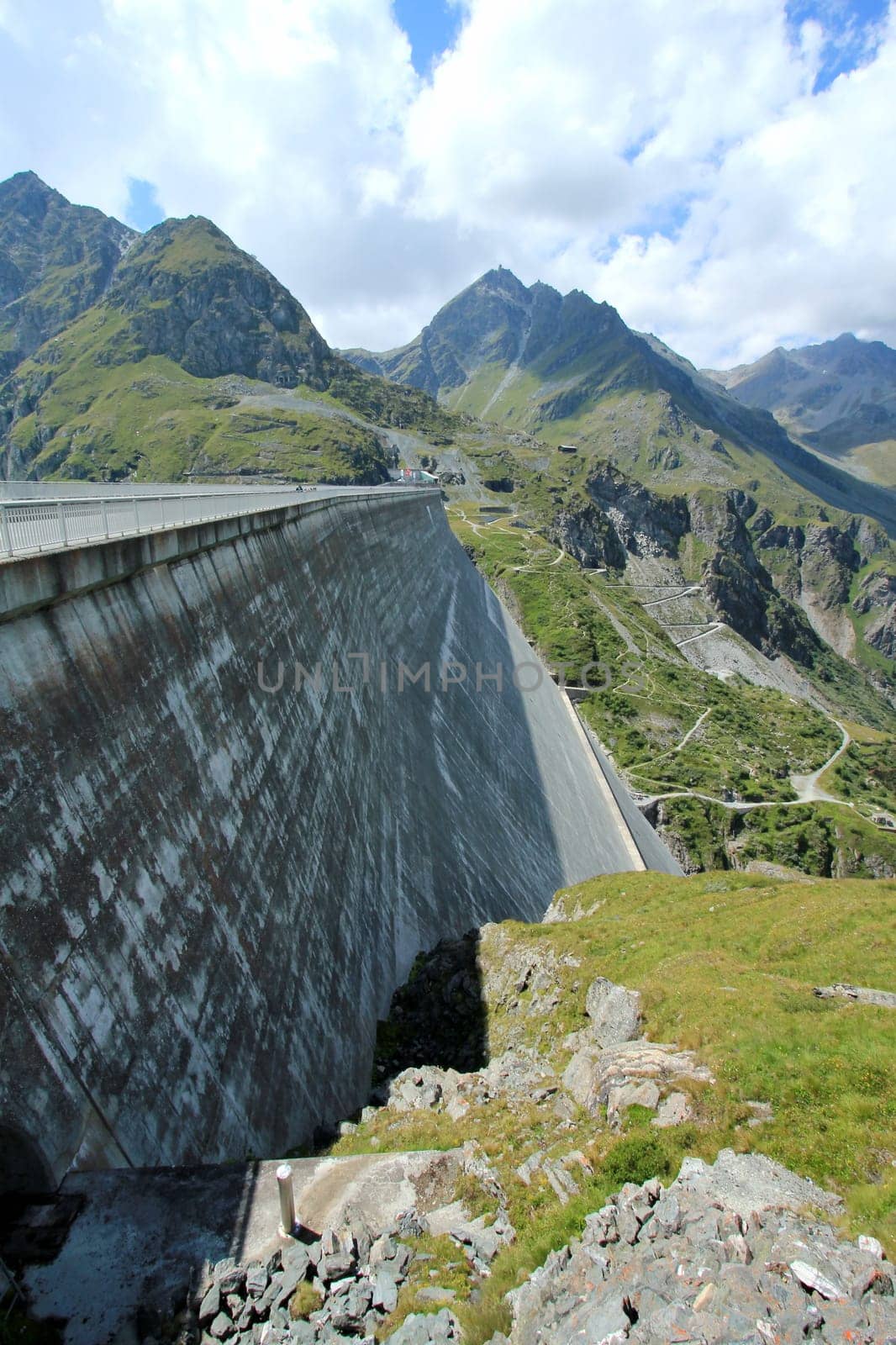 Side of Grande Dixence dam by cloudy but sunny weather, Switzerland