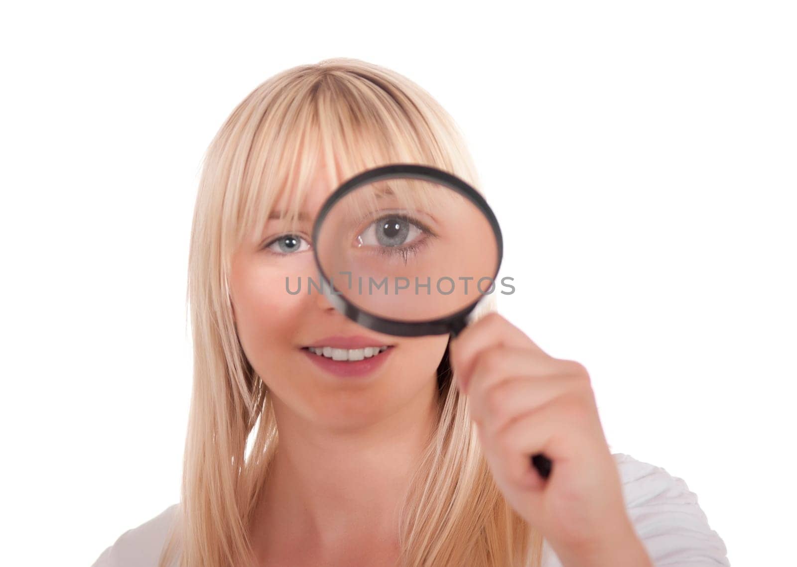 Blonde young woman with magnifying glass