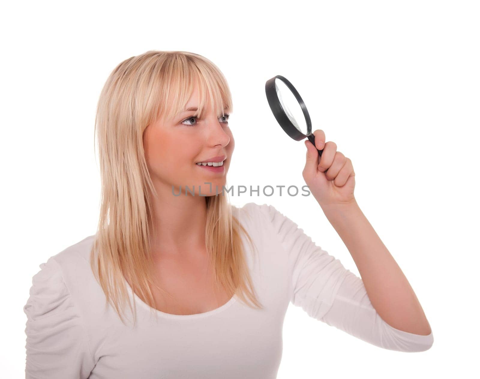 Blonde young woman with magnifying glass