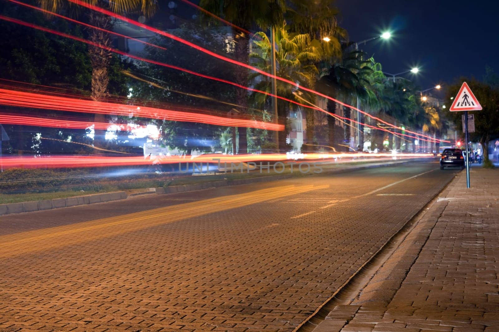 Night road, traces from red headlights of the cars