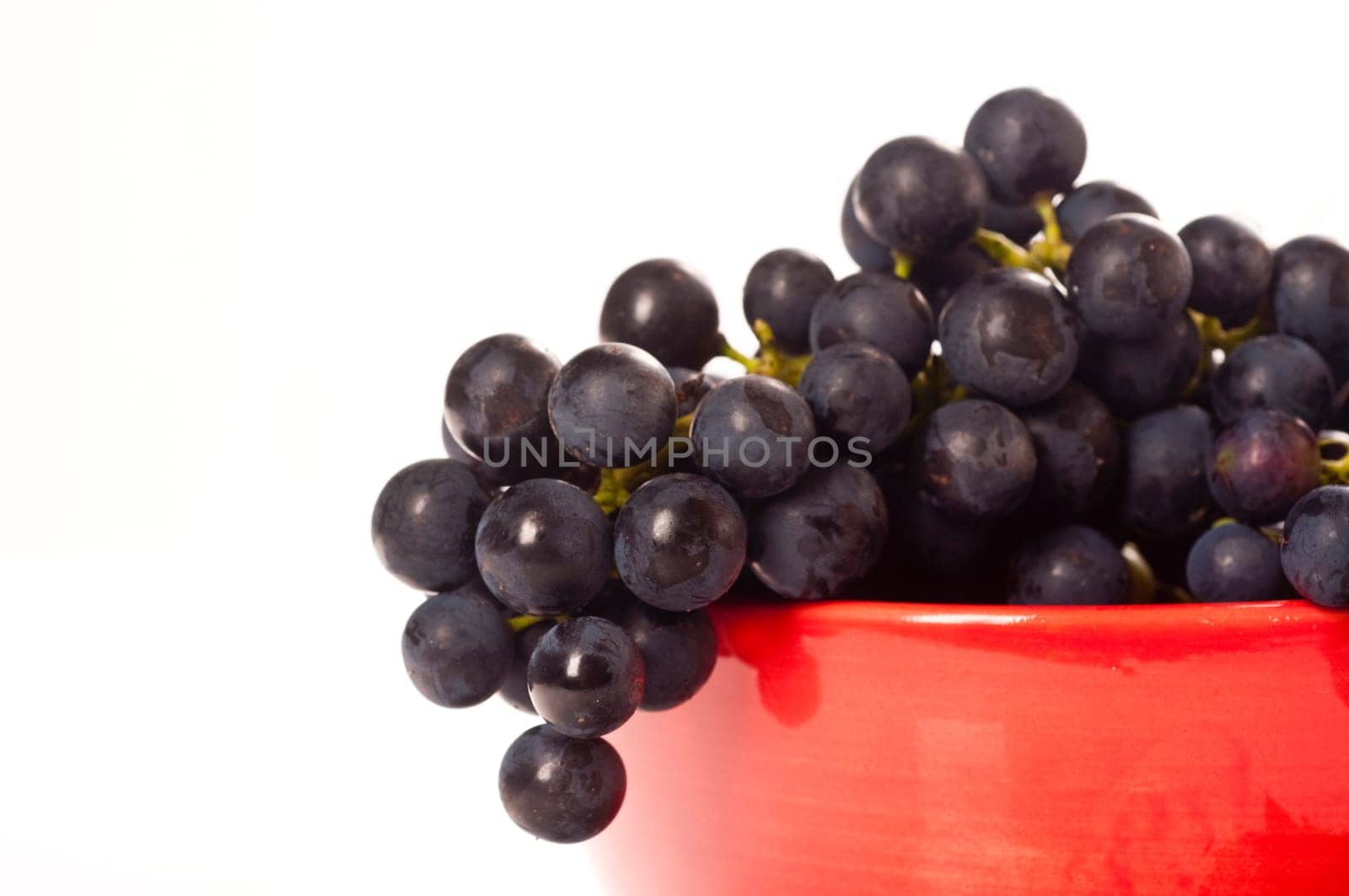 Red grapes in red porcelain bowl