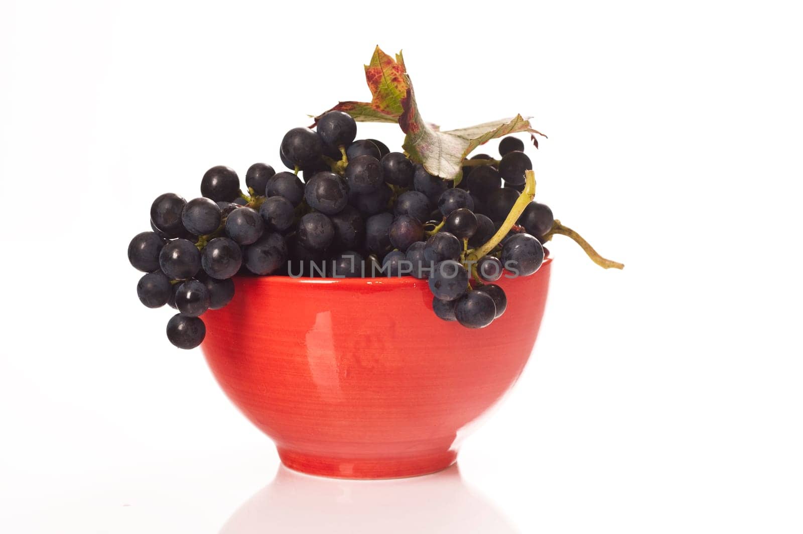 Red grapes in red porcelain bowl