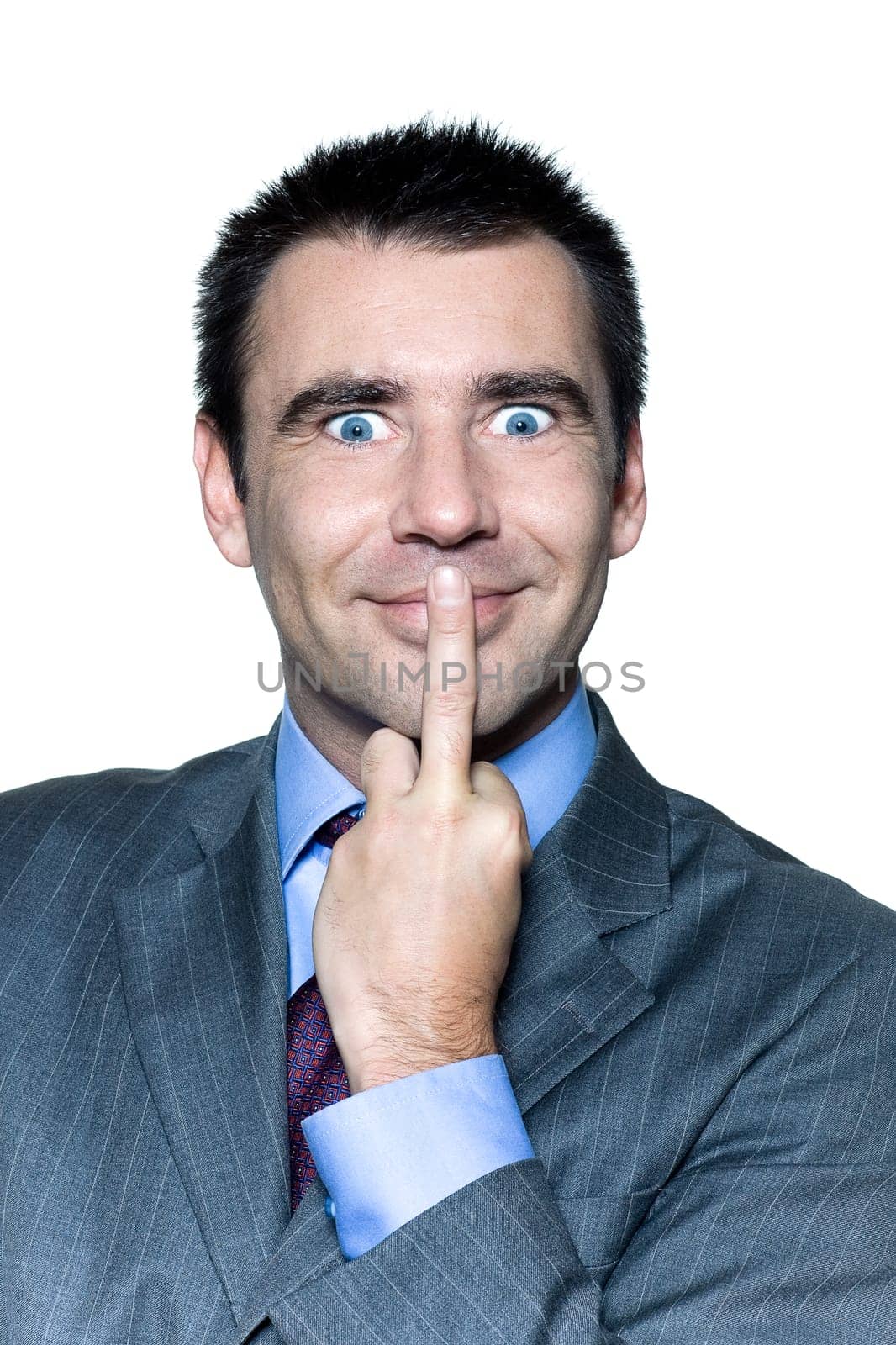 Closeup portrait of an expressive man with middle finger on lips in studio isolated on isolated white background