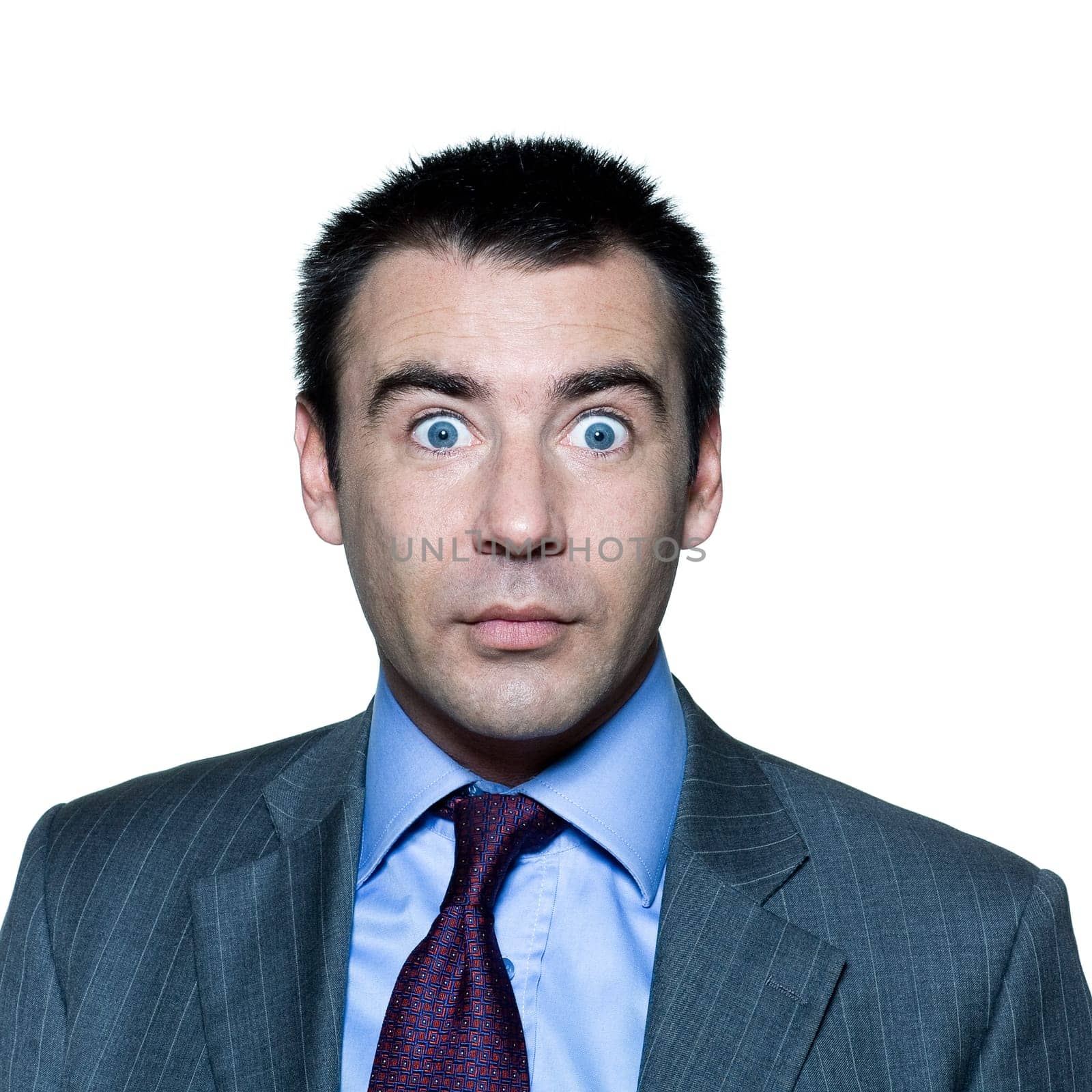 Closeup portrait of a shocked handsome mature man with wide open eyes in studio on isolated white background
