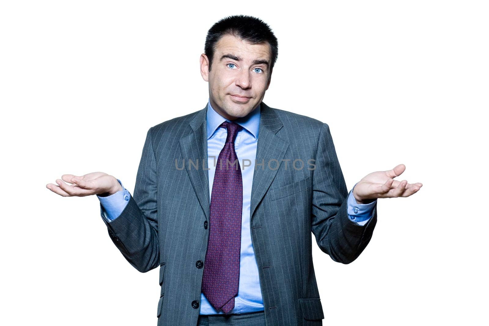 Portrait of confused mature man gesturing in studio on isolated white background