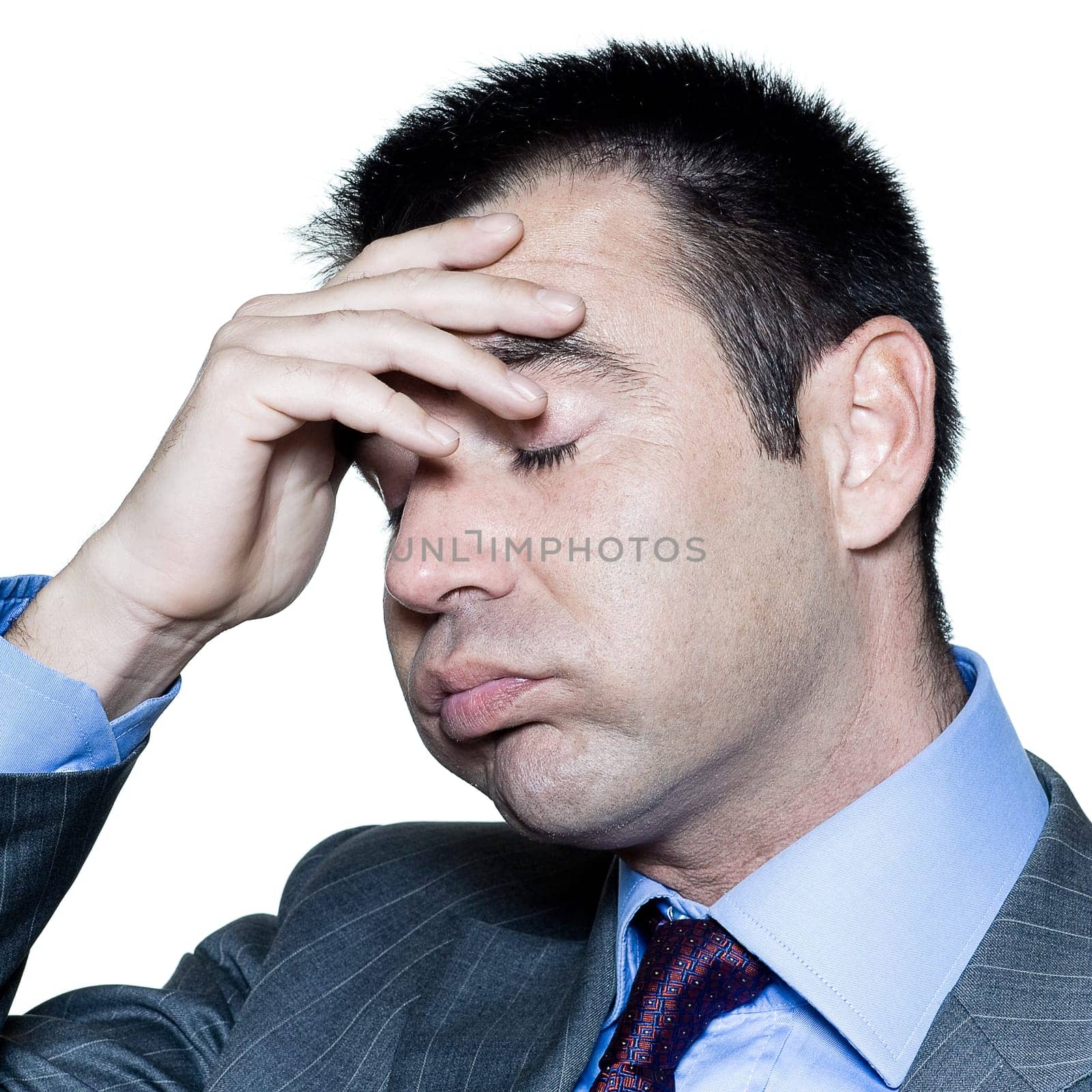 Closeup portrait of a tired businessman with eyes closed in studio on isolated white background